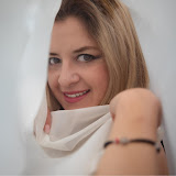 Foto de perfil. Retrato de busto donde visto una camisa con un patrón de flores y palmeras